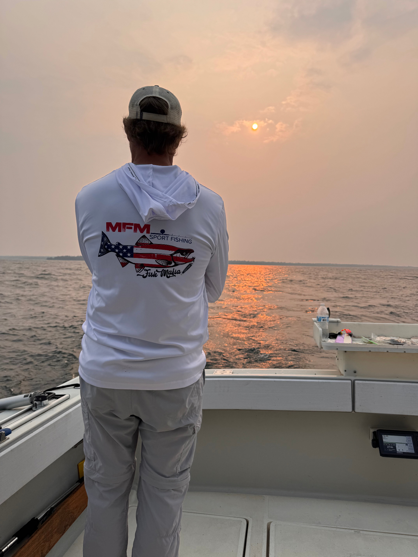 Angler in an MFM hoodie at golden sunset